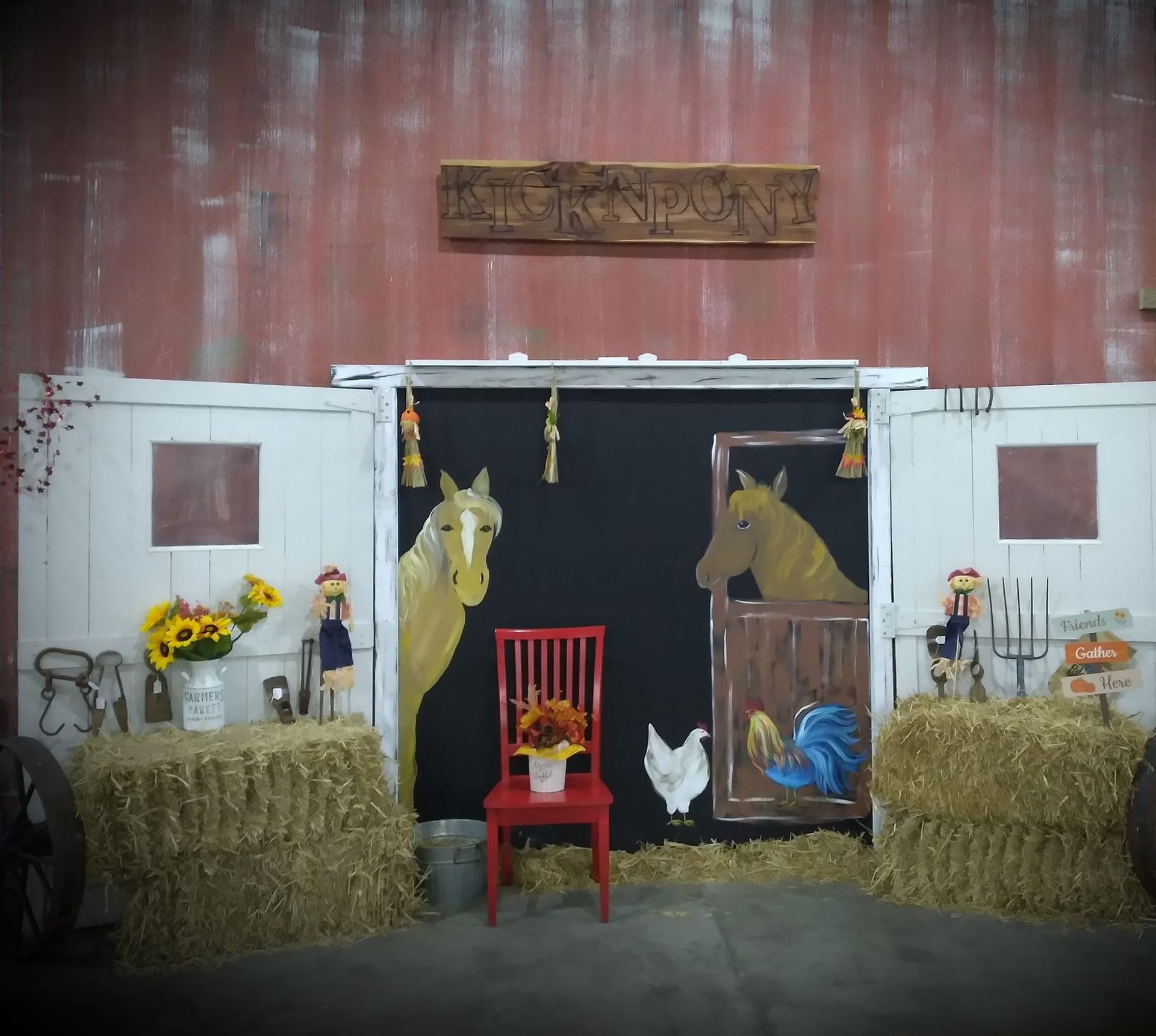 A horse and chicken are painted on a barn door