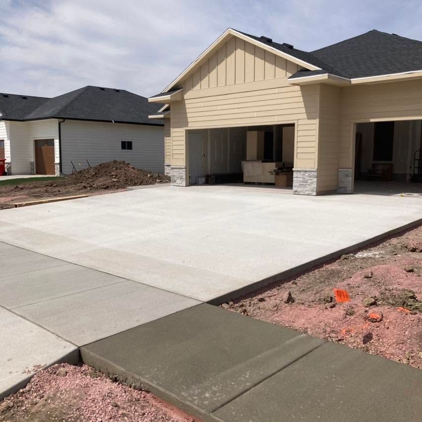 New house with wide concrete driveway and unfinished front yard landscaping