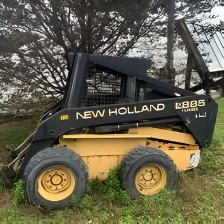 Yellow and black New Holland LB85 skid steer loader on grass at REIMOLDS Nursery