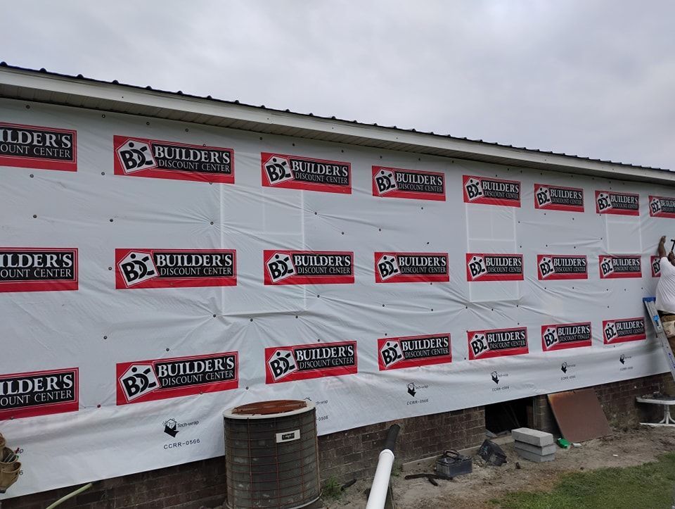 A person installs house wrap printed with 