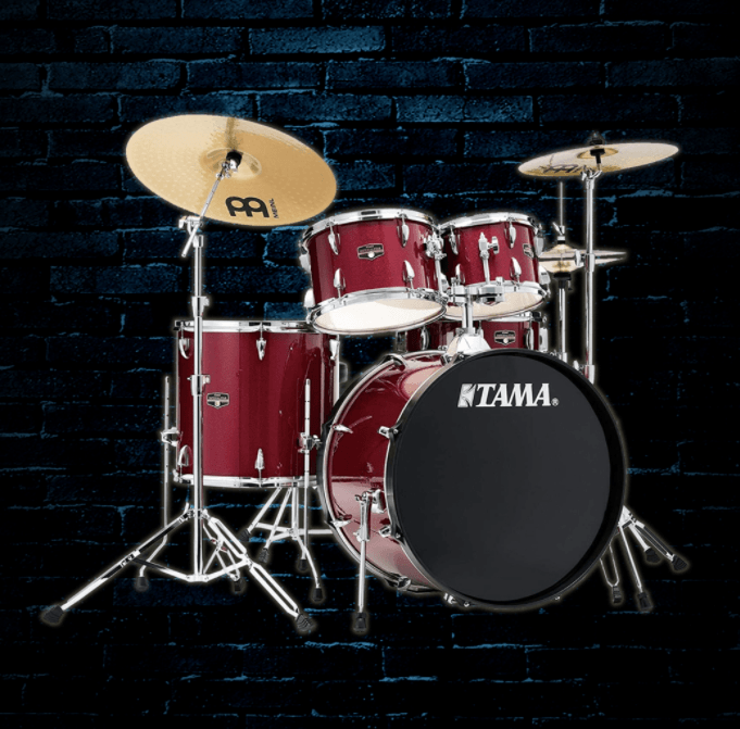 A red tama drum set against a brick wall