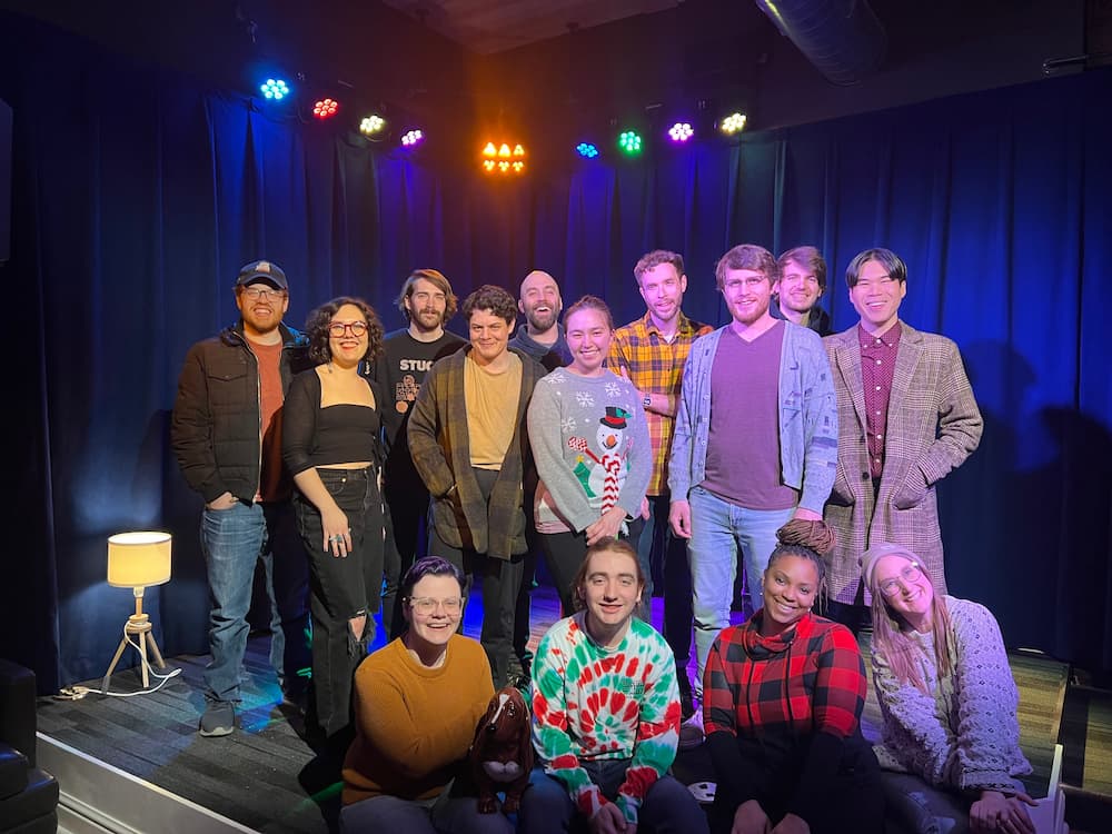A group of people are posing for a picture on a stage.