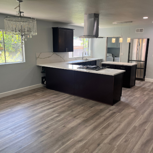 A kitchen with a large island and stainless steel appliances