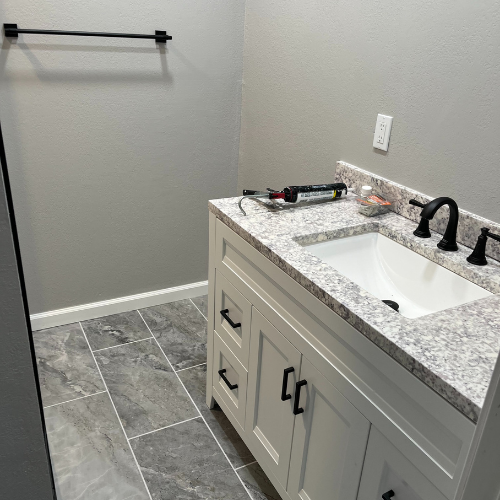 A bathroom with a sink and a towel rack