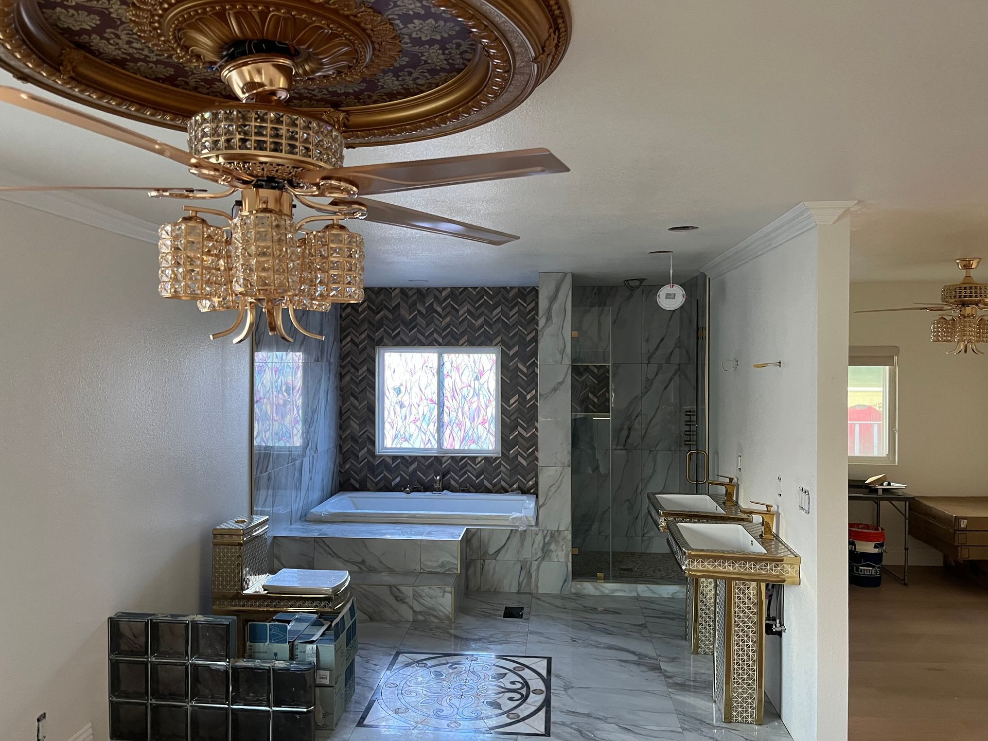 A bathroom with two sinks and a ceiling fan