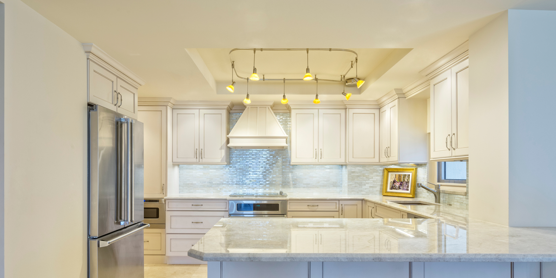 A kitchen with white cabinets and stainless steel appliances.