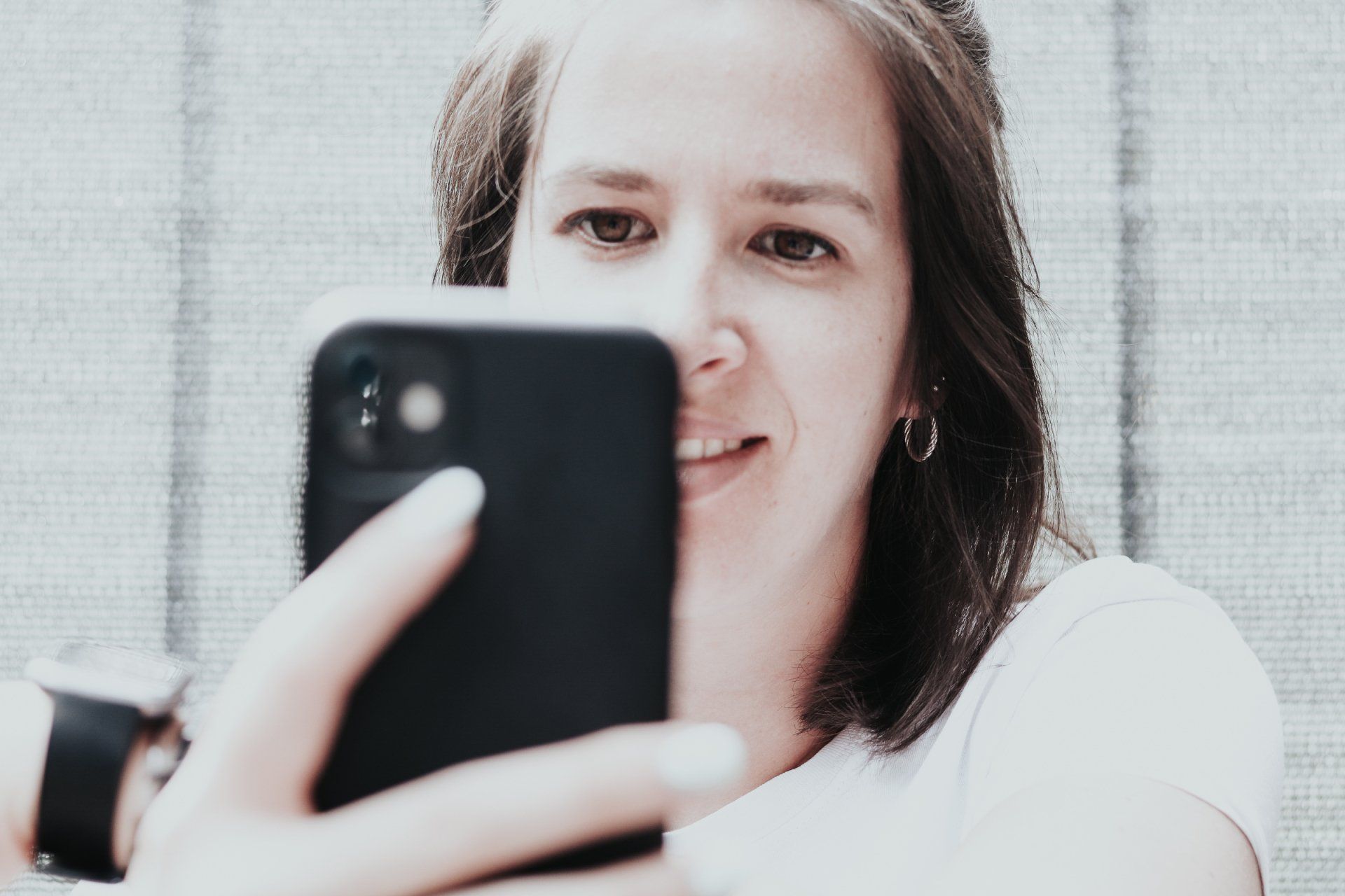Eine Frau schaut in ihr Handy.