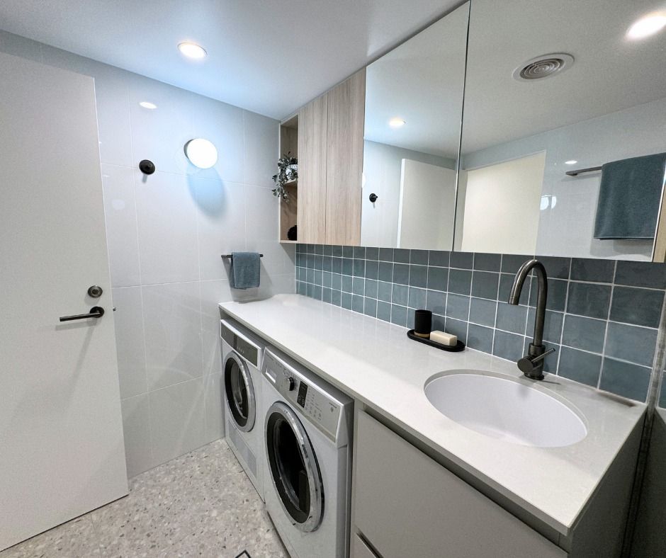 Modern Laundry Room With White Cabinets, Grey Countertops, and Washing Machine — Nyblad Construction in Caloundra West, QLD