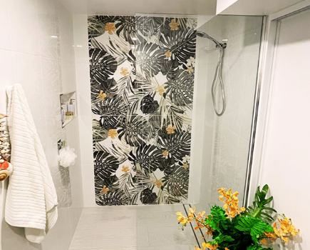 A Bathroom With A Walk-In Shower And A Floral Tile Wall — Nyblad Construction in Caloundra West, QLD