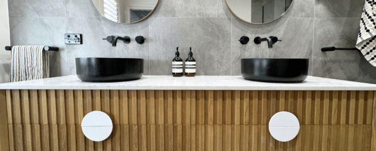 A bathroom with two black sinks and two mirrors — Nyblad Construction in Caloundra West, QLD