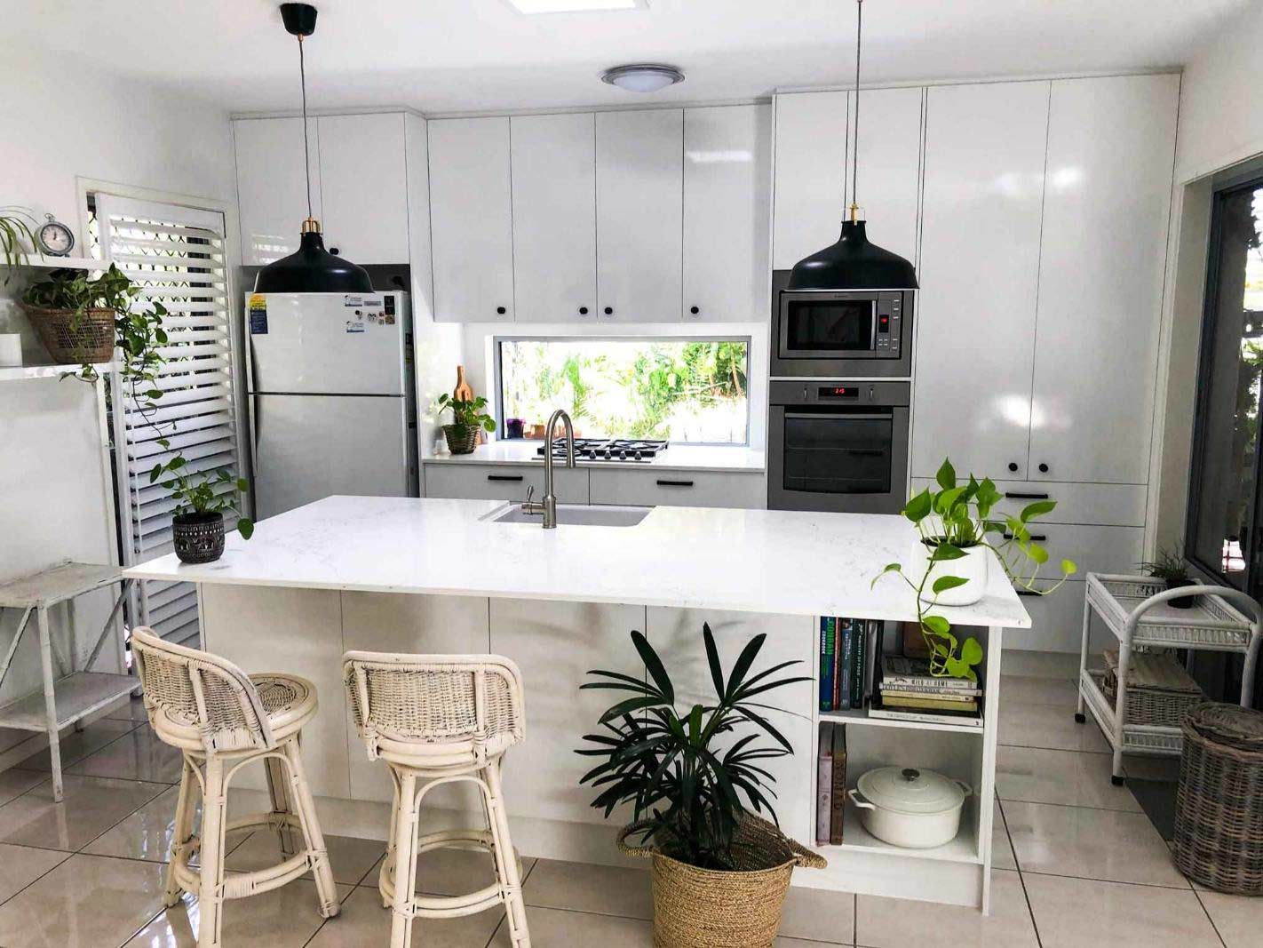 A Large Island, Stools, A Refrigerator, And A Microwave In The Kitchen — Nyblad Construction in Caloundra West, QLD