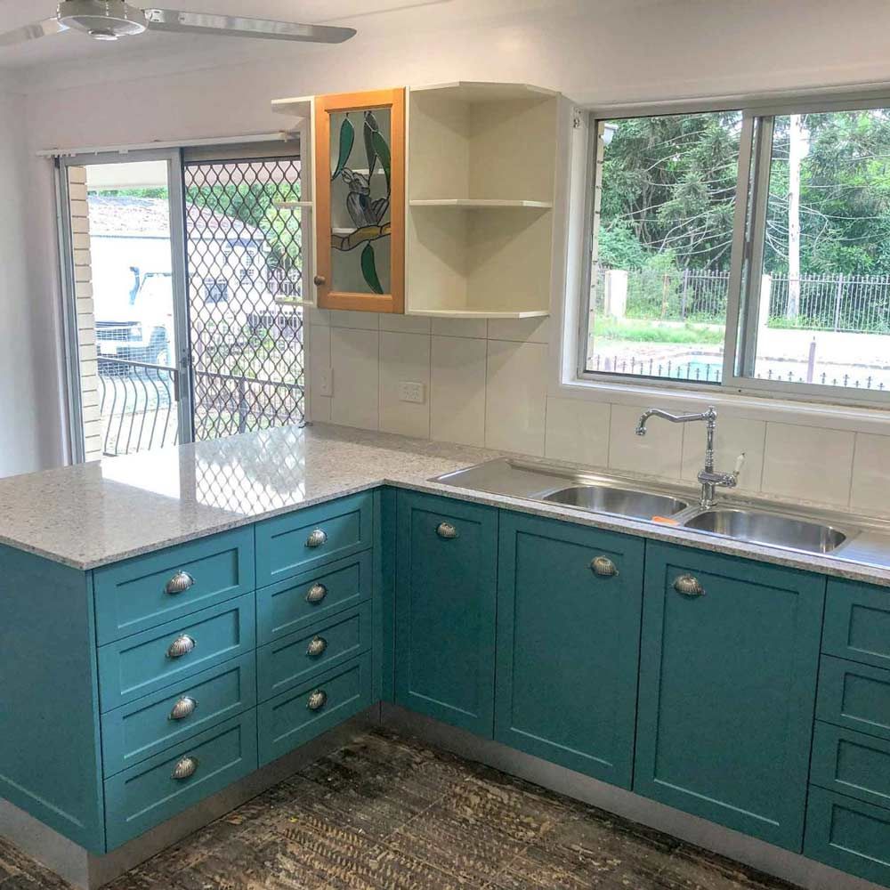 A New Kitchen With Blue Cabinets And A Sink — Nyblad Construction in Caloundra West, QLD