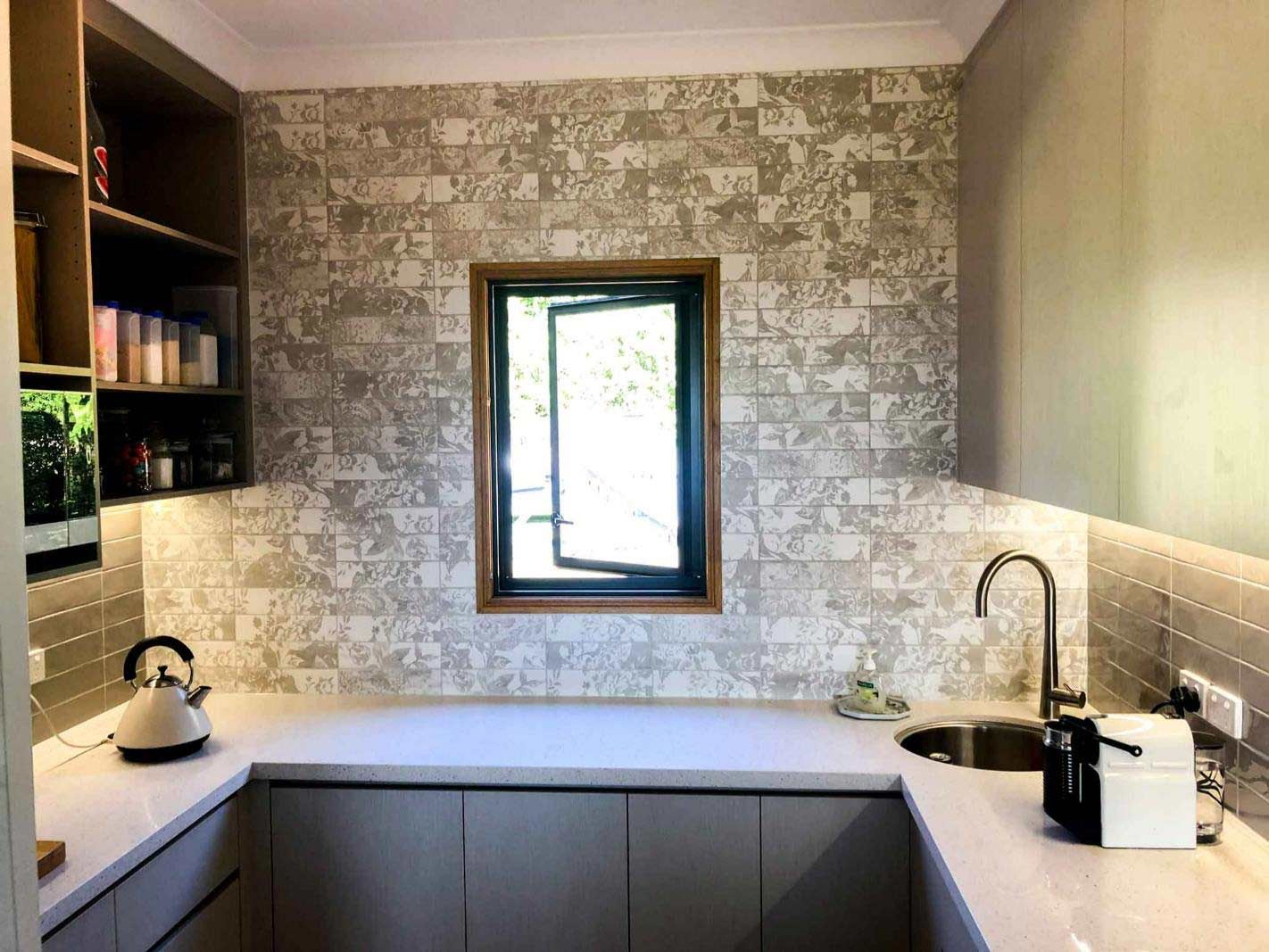 Modern Kitchen With Decorative Splashback Tiles — Nyblad Construction in Caloundra West, QLD