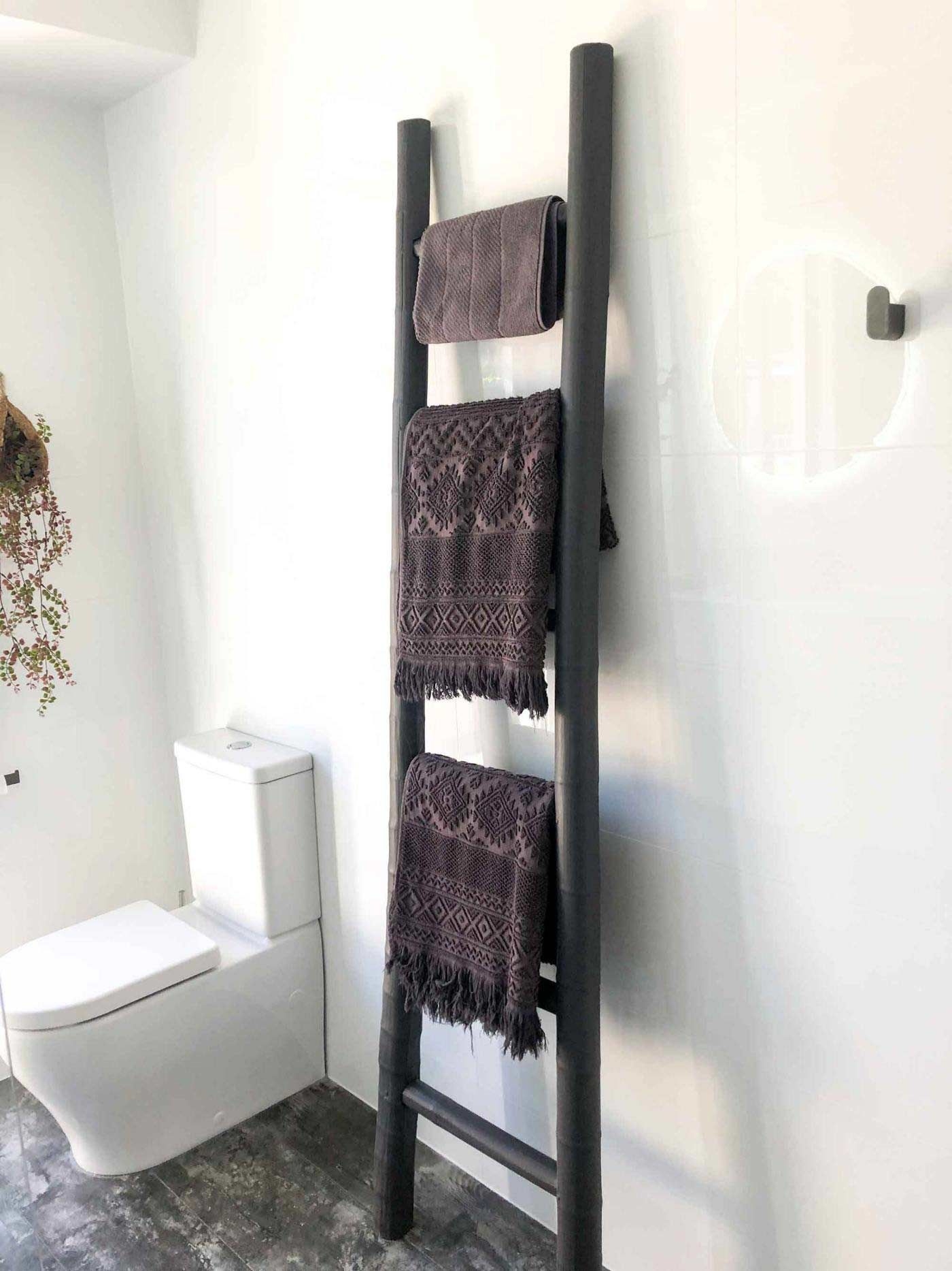 A Bathroom With A Toilet And A Ladder With Towels On It — Nyblad Construction in Caloundra West, QLD