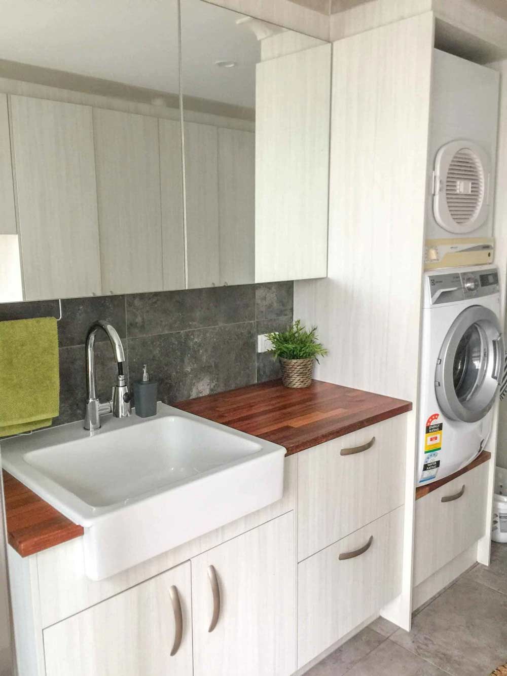 A Bathroom With A Sink , Washer And Dryer — Nyblad Construction in Caloundra West, QLD
