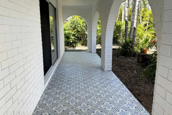 A White Brick Porch With A Tiled Floor And Arches — Nyblad Construction in Caloundra West, QLD