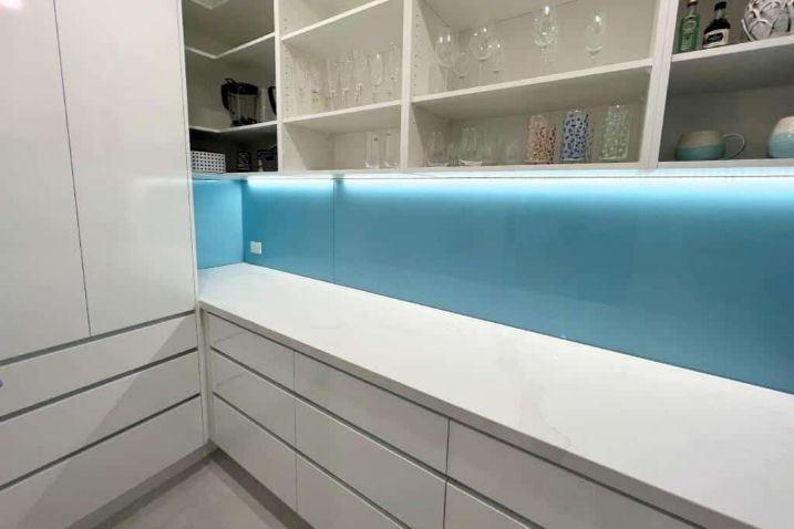 A Kitchen With White Cabinets And A Blue Backsplash — Nyblad Construction in Caloundra West, QLD