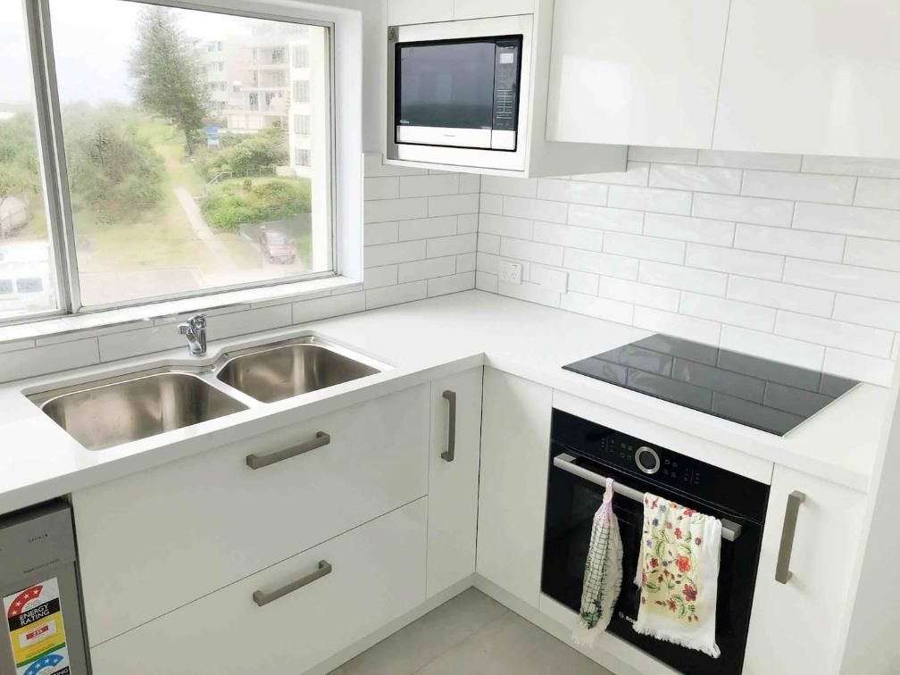 A Kitchen With Two Sinks  And A Stove — Nyblad Construction in Caloundra West, QLD