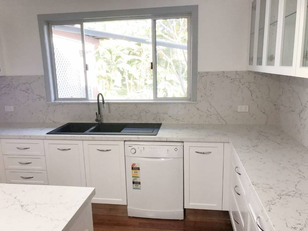 A Kitchen With White Cabinets And Kitchen Sink — Nyblad Construction in Caloundra West, QLD
