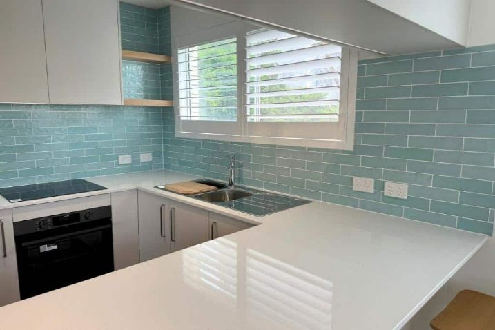 A Kitchen With Blue Tiles — Nyblad Construction in Caloundra West, QLD