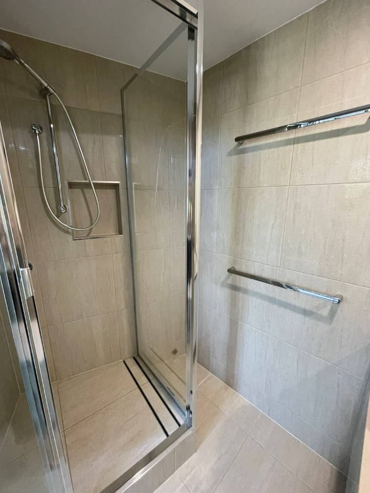 A Bathroom With A Walk In Shower With A Glass Door — Nyblad Construction in Caloundra West, QLD