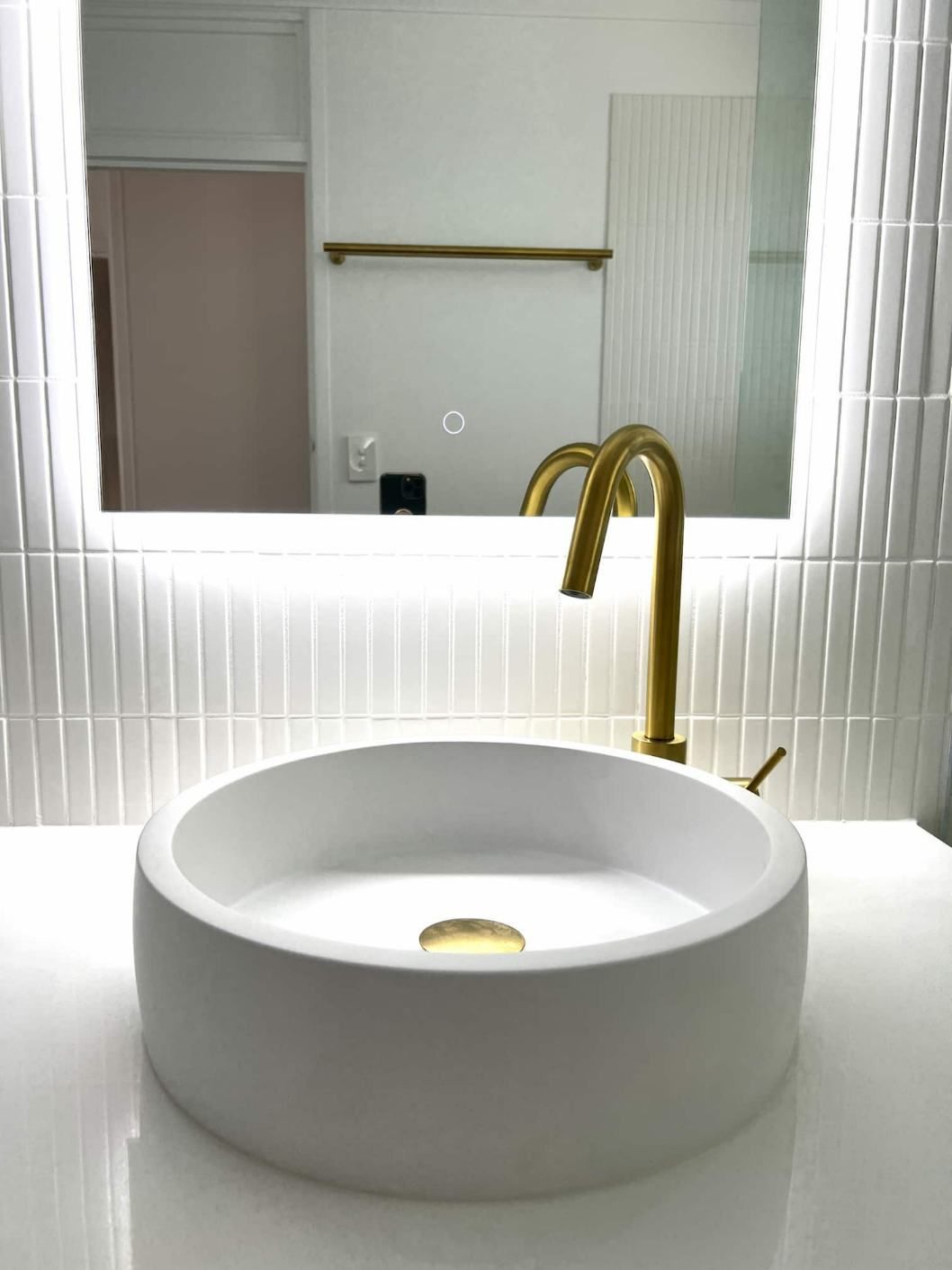 A Stylish Bathroom Showcasing A Round Sink And A Mirror — Nyblad Construction in Caloundra West, QLD