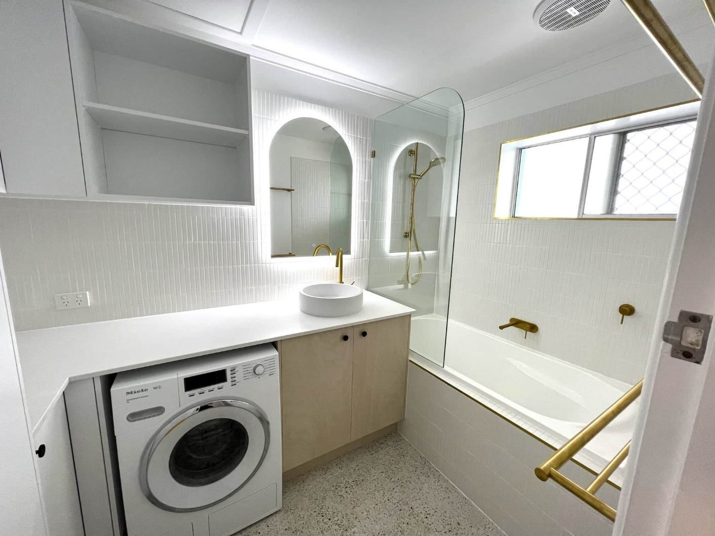 A Bathroom With A Washing Machine — Nyblad Construction in Caloundra West, QLD