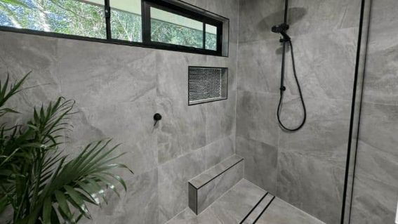 A Bathroom With A Walk In Shower And A Window — Nyblad Construction in Caloundra West, QLD
