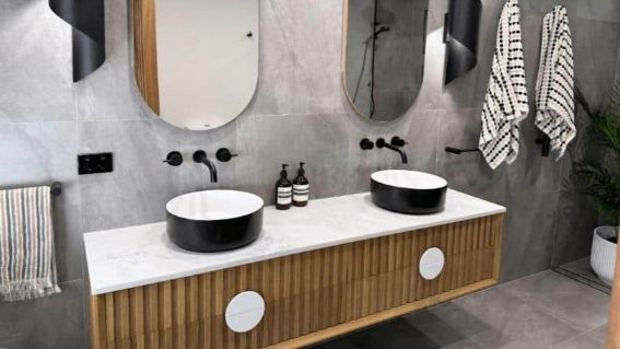 A Bathroom With Two Sinks, Two Mirrors, And Towels Hanging On The Wall — Nyblad Construction in Caloundra West, QLD