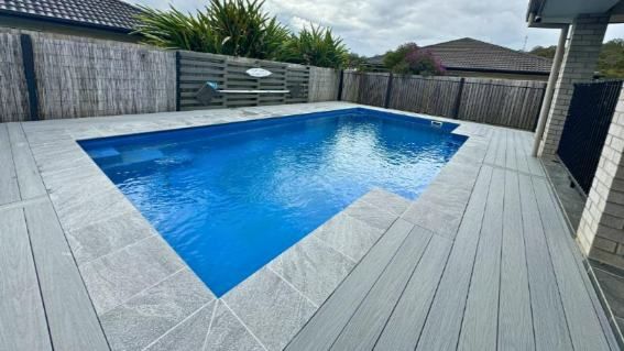 A Large Swimming Pool Is Sitting On Top Of A Wooden Deck — Nyblad Construction in Caloundra West, QLD