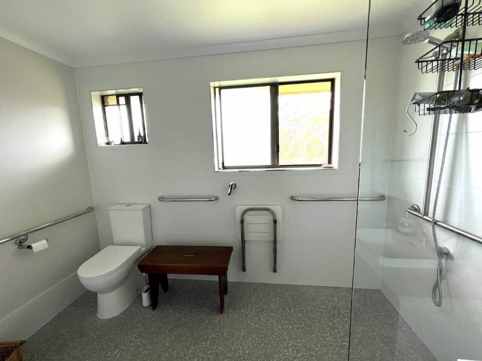 A Modern Bathroom Complete With A Toilet, A Bench, And A Window — Nyblad Construction in Caloundra West, QLD