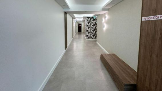 A Long Hallway With A Wooden Bench In The Middle — Nyblad Construction in Caloundra West, QLD