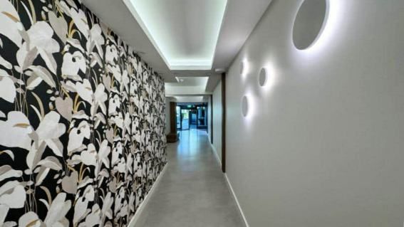 A Long Hallway With A Floral Wallpaper On The Wall — Nyblad Construction in Caloundra West, QLD