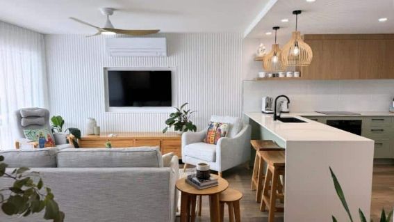  Living Room With A Couch, Chair, Television, And A Kitchen — Nyblad Construction in Caloundra West, QLD