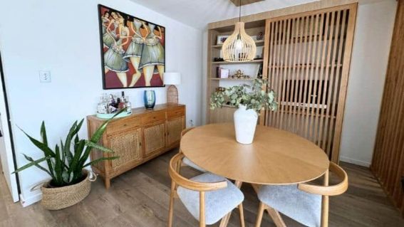A Dining Space With A Wooden Round Table And Matching Chairs — Nyblad Construction in Caloundra West, QLD