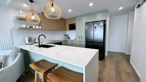 A Contemporary Kitchen Featuring A Big Island  — Nyblad Construction in Caloundra West, QLD
