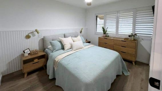 A Bedroom With A Bed, Dresser, Nightstand, And Window — Nyblad Construction in Caloundra West, QLD