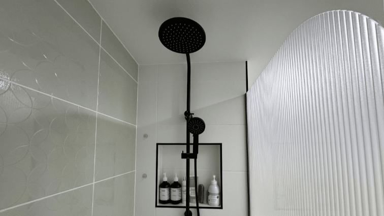 A Shower Head Is Hanging From The Ceiling In A Bathroom — Nyblad Construction in Caloundra West, QLD