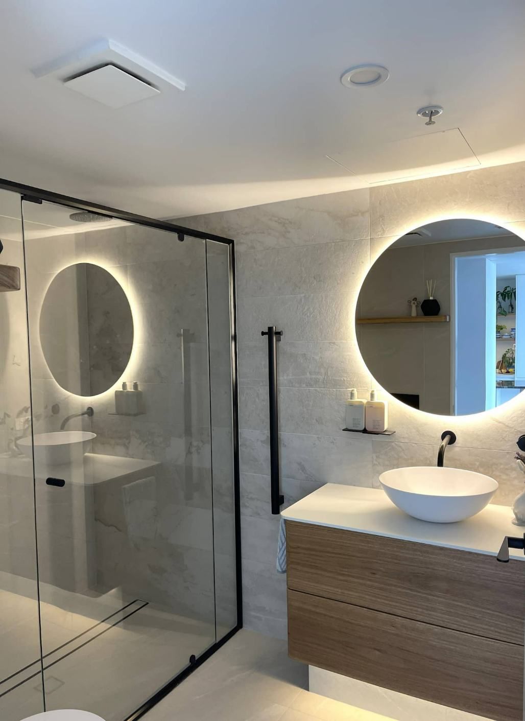 Big Round Mirror In The Bathroom With Lights — Nyblad Construction in Caloundra West, QLD