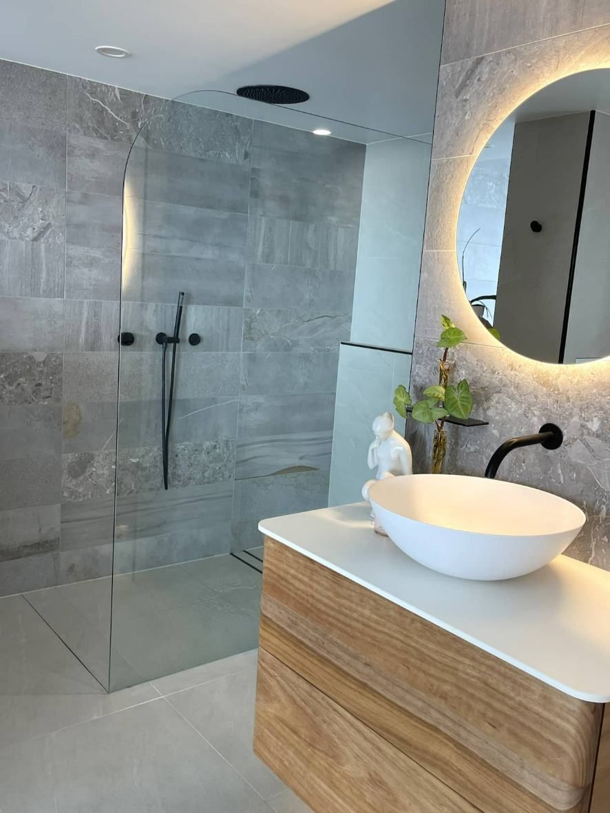Interior Of Light Bathroom With Shower Glass , Wooden Cabinet And Mirror — Nyblad Construction in Caloundra West, QLD
