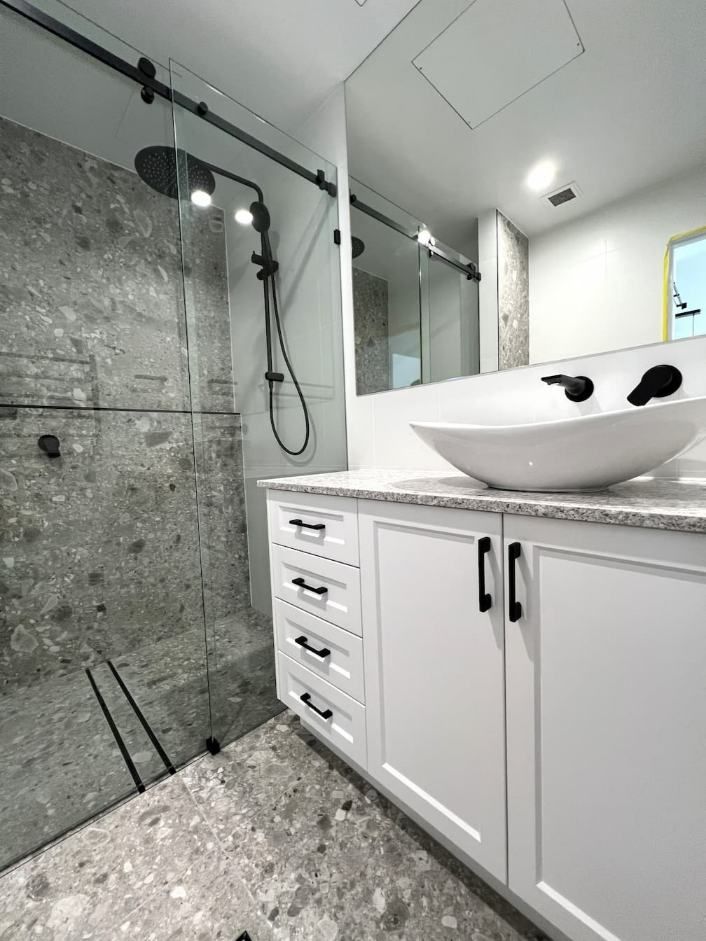 A Stylish Bathroom Showcasing A Sink And A Walk-in Shower — Nyblad Construction in Caloundra West, QLD