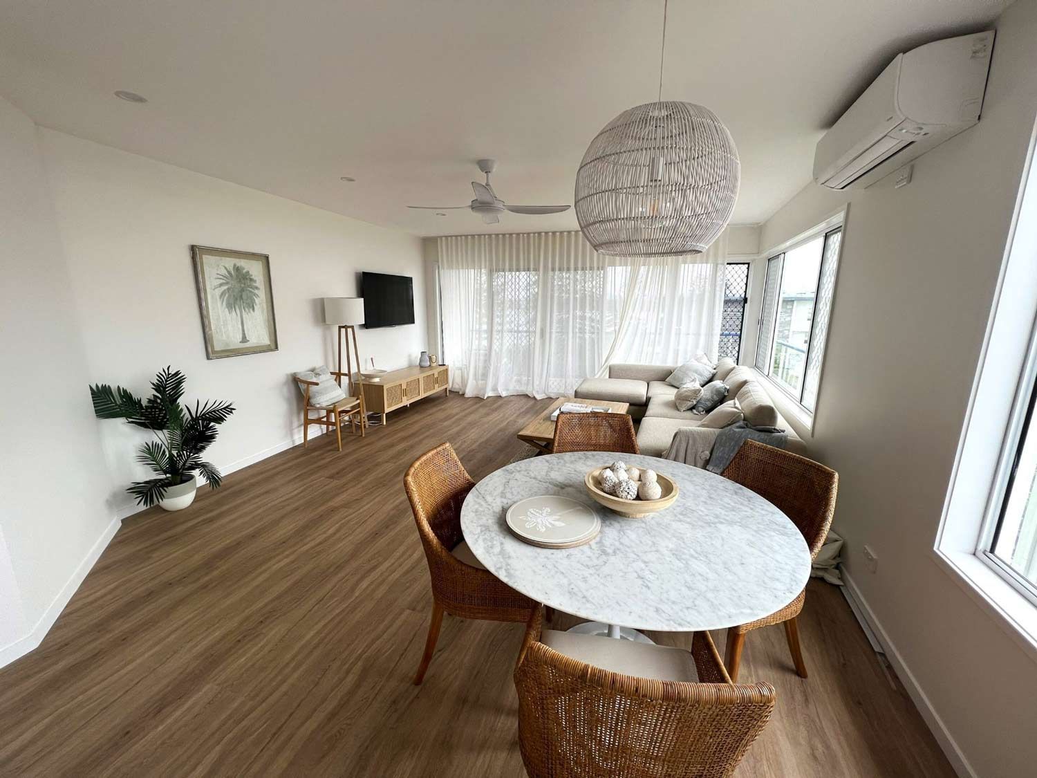 Living Room With A Circle Dining Table And Chairs And A Couch — Nyblad Construction in Caloundra West, QLD