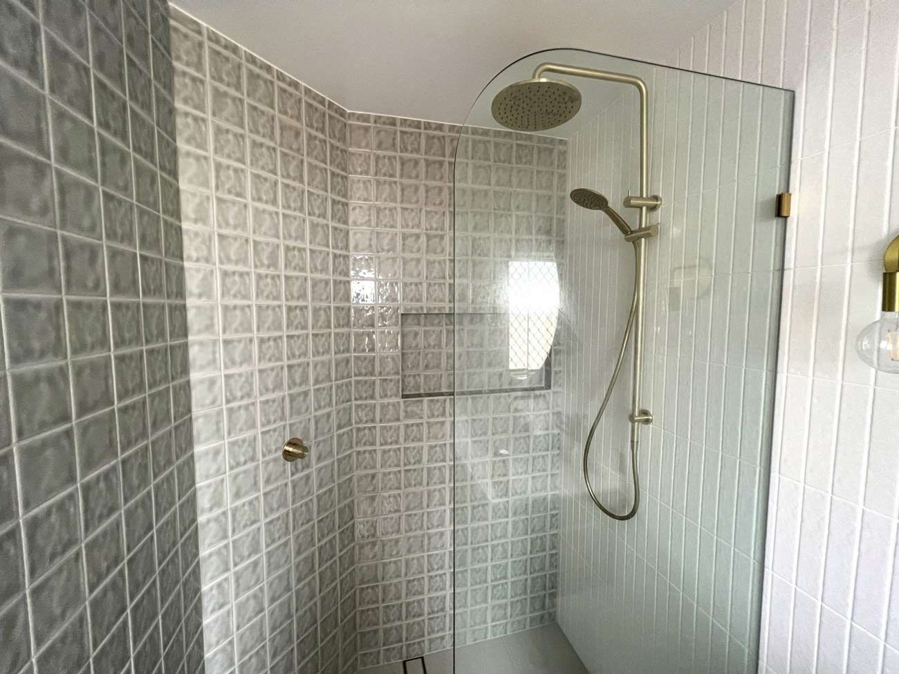 There Is A Shower With A Glass Door And A Shower Head — Nyblad Construction in Caloundra West, QLD