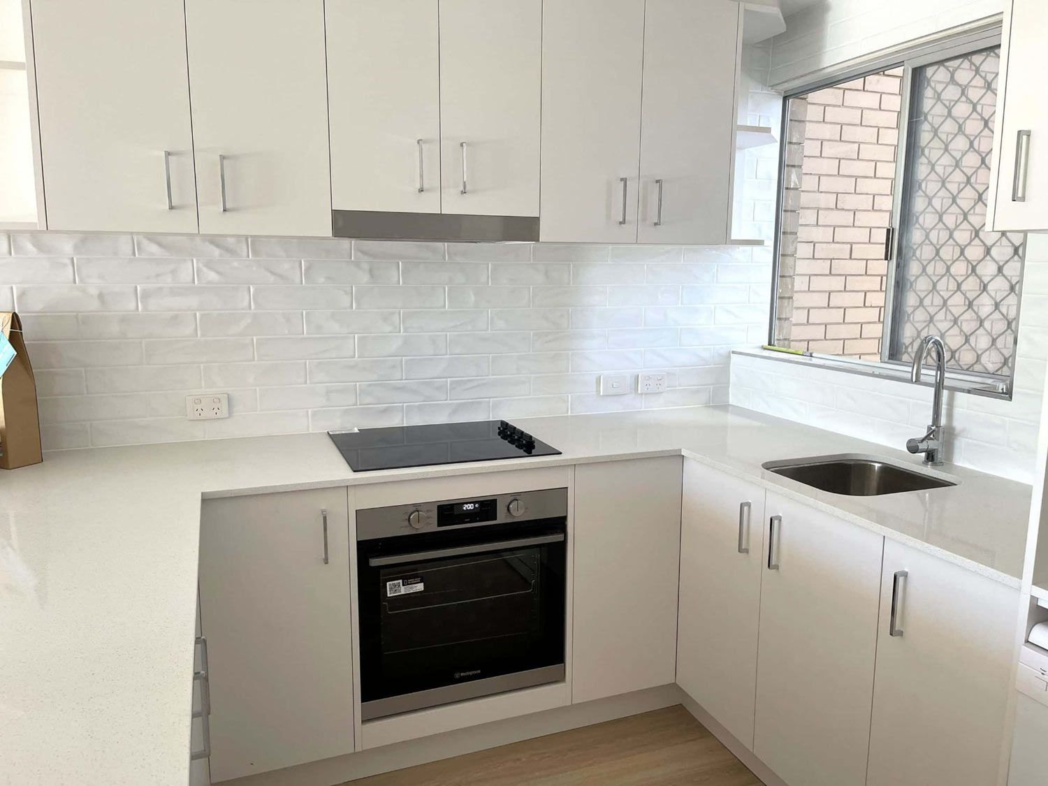  White Cabinets With Oven In The Newly Finish Kitchen — Nyblad Construction in Caloundra West, QLD