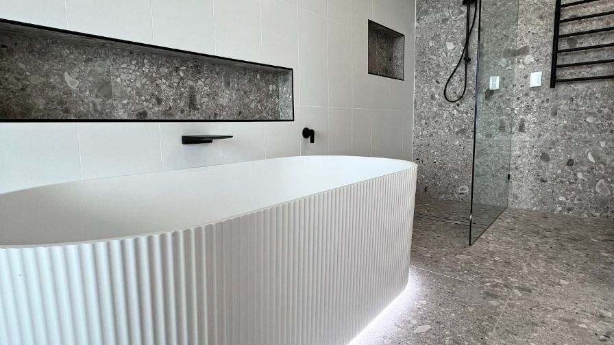 A Bathroom With A Bathtub And A Walk In Shower — Nyblad Construction in Caloundra West, QLD
