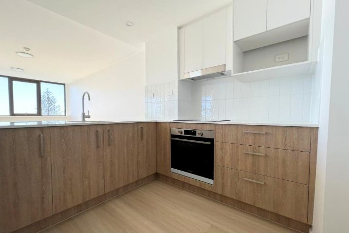 A Kitchen With Wooden Cabinets — Nyblad Construction in Caloundra West, QLD