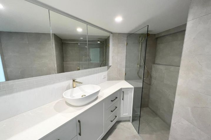 White Cabinet And Sink With Large Mirror In The Bathroom — Nyblad Construction in Caloundra West, QLD