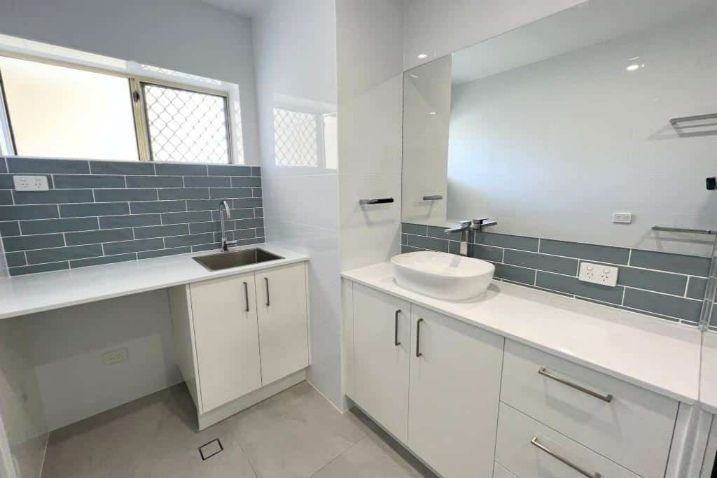  Bathroom Equipped With A Mirror, Sink, And Cabinets 
— Nyblad Construction in Caloundra West, QLD