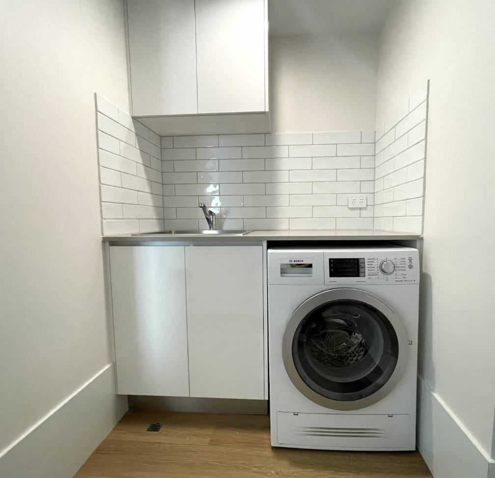 A Laundry Room With A Washer And Dryer And A Sink — Nyblad Construction in Caloundra West, QLD