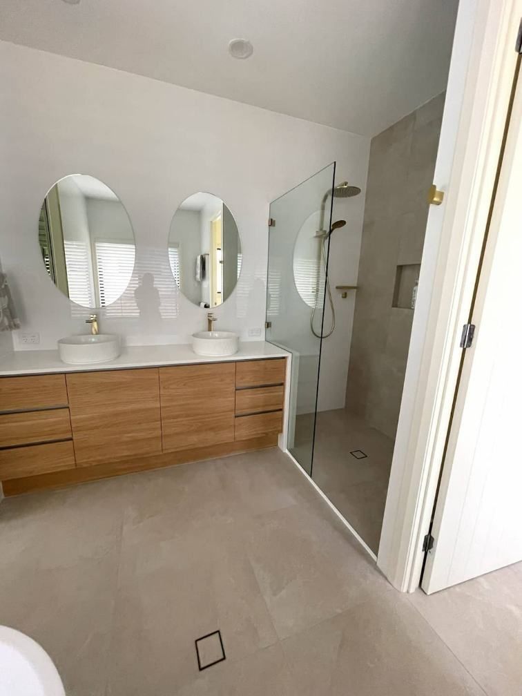 A Bathroom With Two Sinks And A Walk In Shower — Nyblad Construction in Caloundra West, QLD
